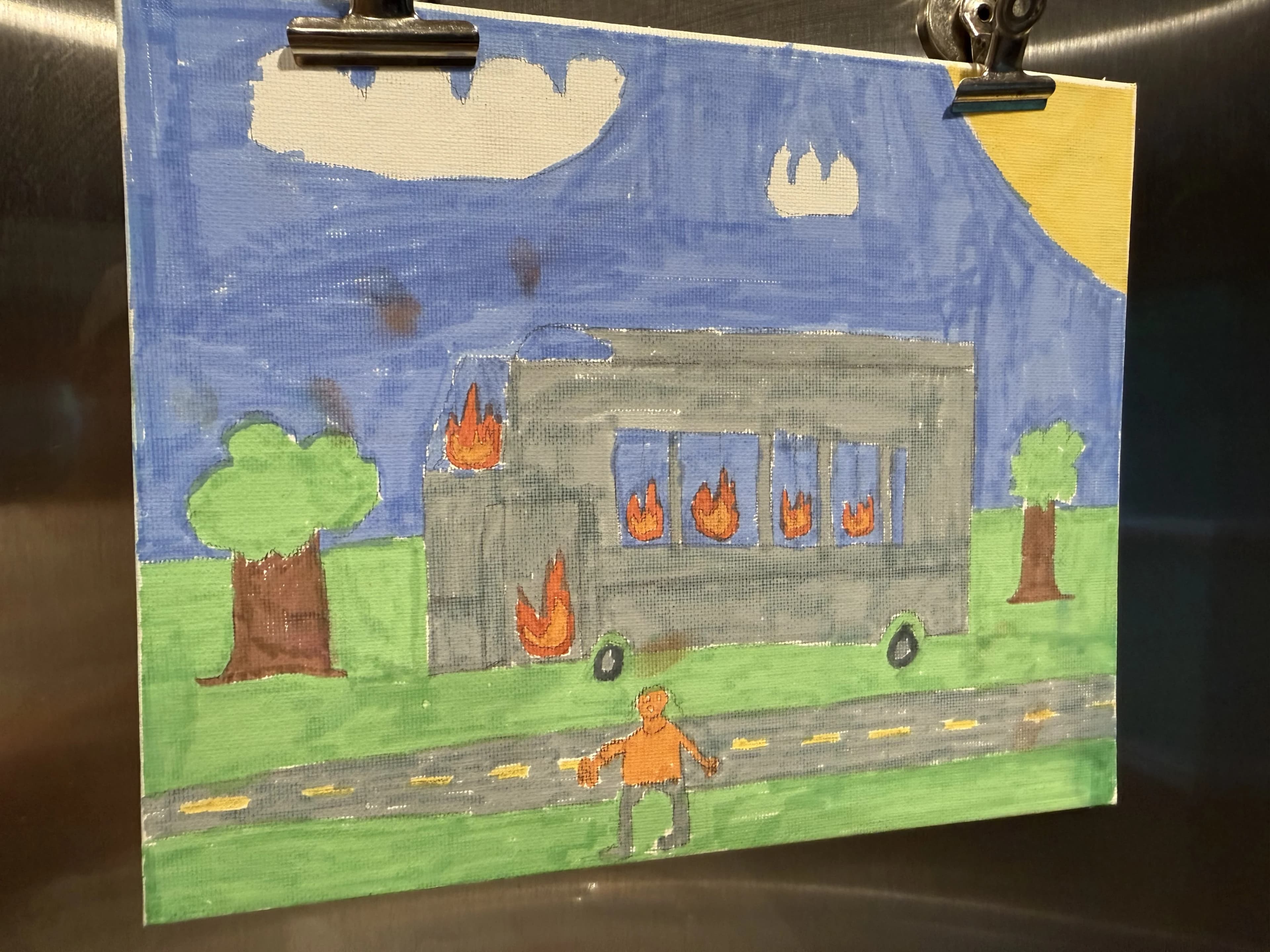 A child's painting of the Freedom Riders bus on fire, a lone figure standing in front of the flames