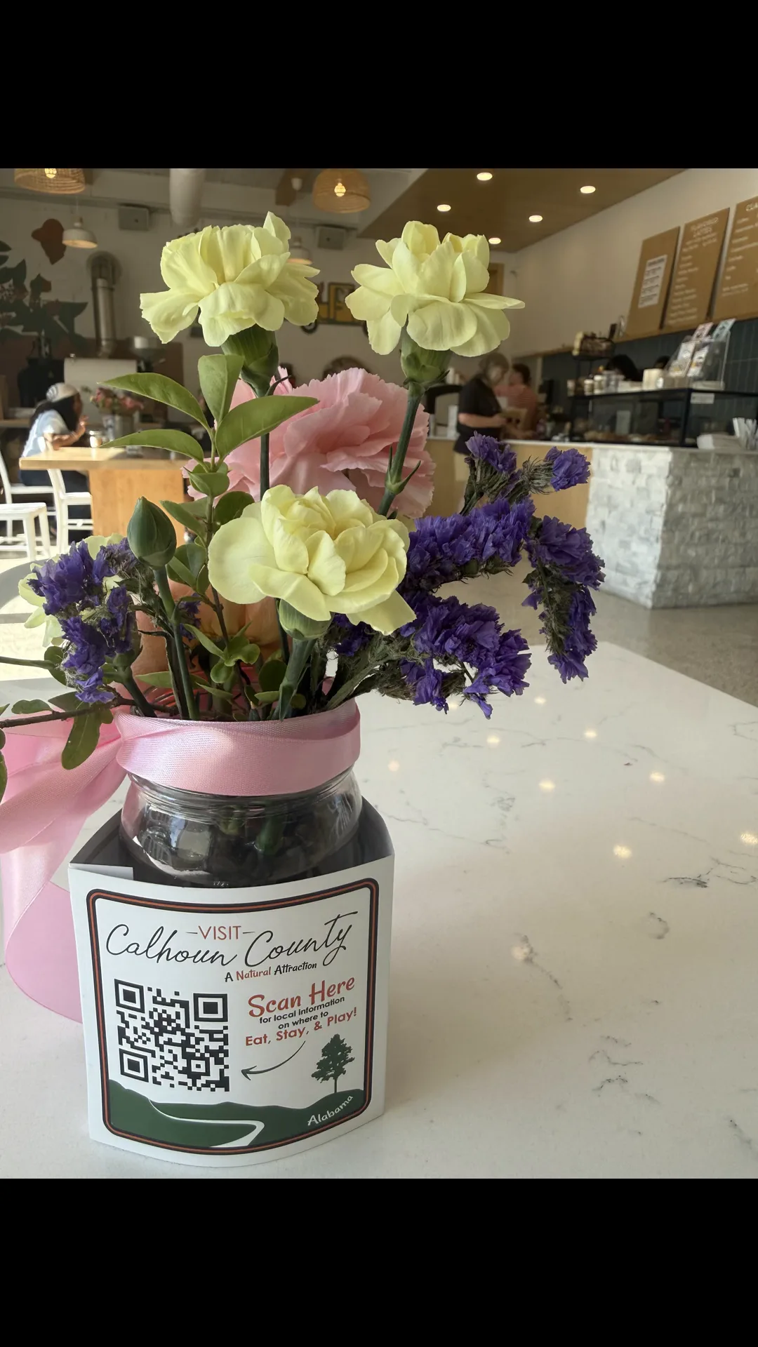 Locally grown flowers on the counter at Called Coffee in Anniston